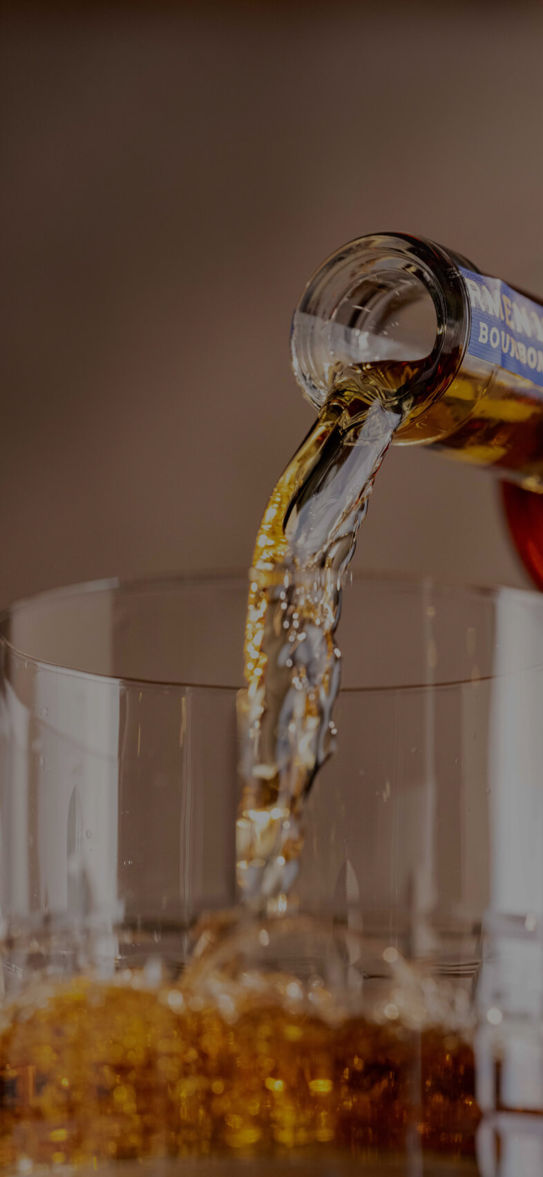 barmen bottle pouring whiskey on glass